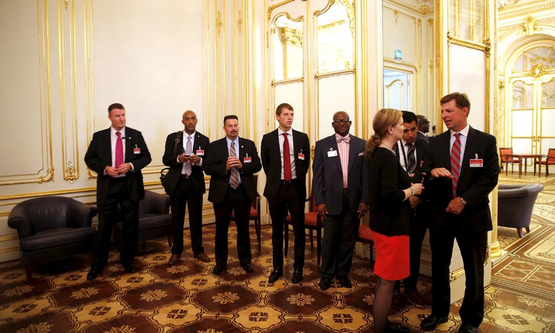 Members of US delegation wait outside a room where a meeting between John Kerry and Javad Zarif is being held at the Palais Coburg hotel in Vienna. —Reuters  File
