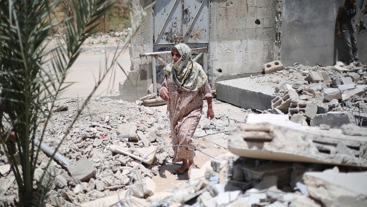 A Palestinian woman walks amid the rubble of buildings which were destroyed during the 50-day war between Israel and Hamas militants in the summer of 2014 in the village of Khuzaa east of Khan Yunis in the southern Gaza Strip A Palestinian woman walks amid the rubble of buildings which were destroyed during the 50-day war between Israel and Hamas militants in the summer of 2014 in the village of Khuzaa east of Khan Yunis in the southern Gaza Strip